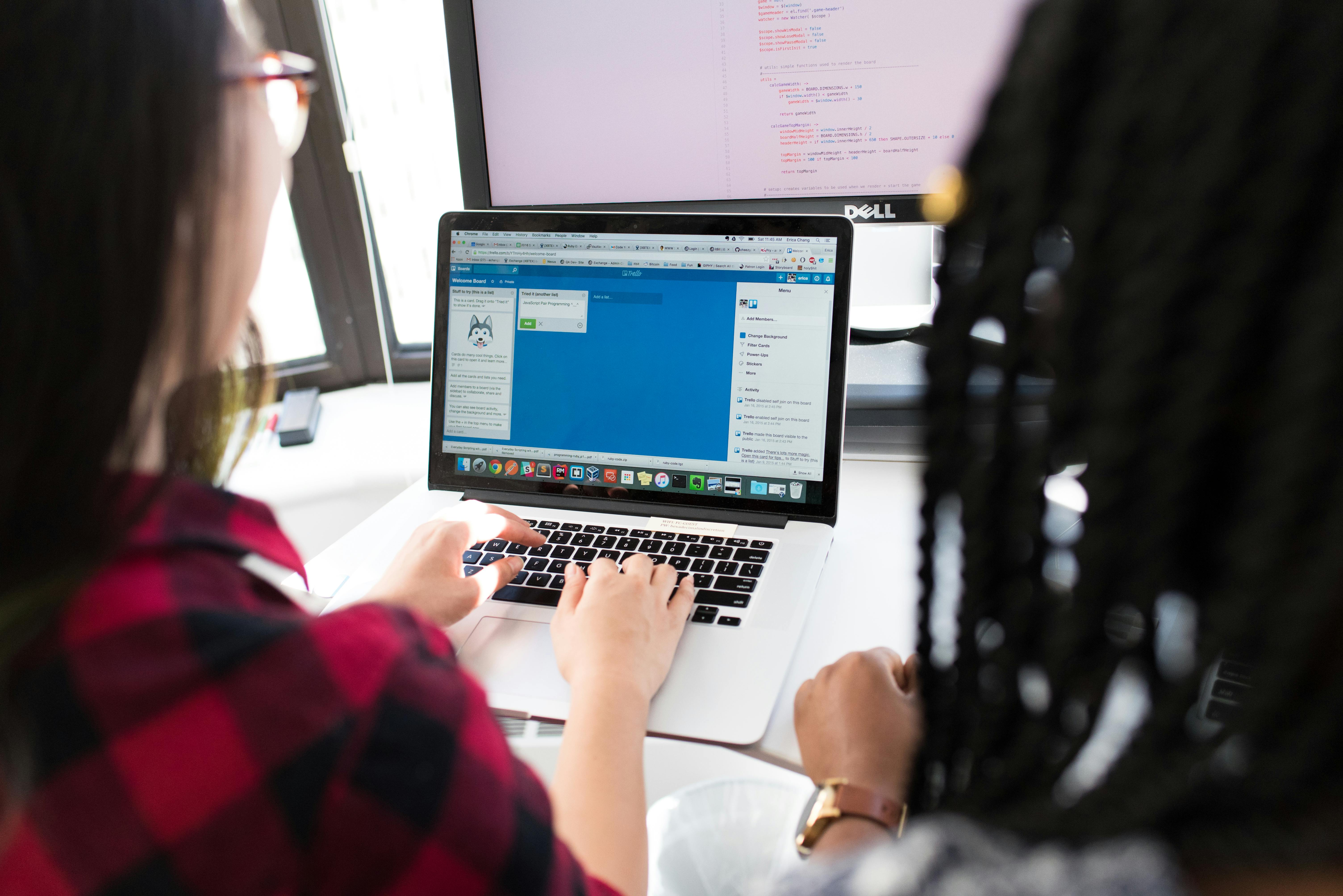 Designer working at a desk with a laptop and color samples